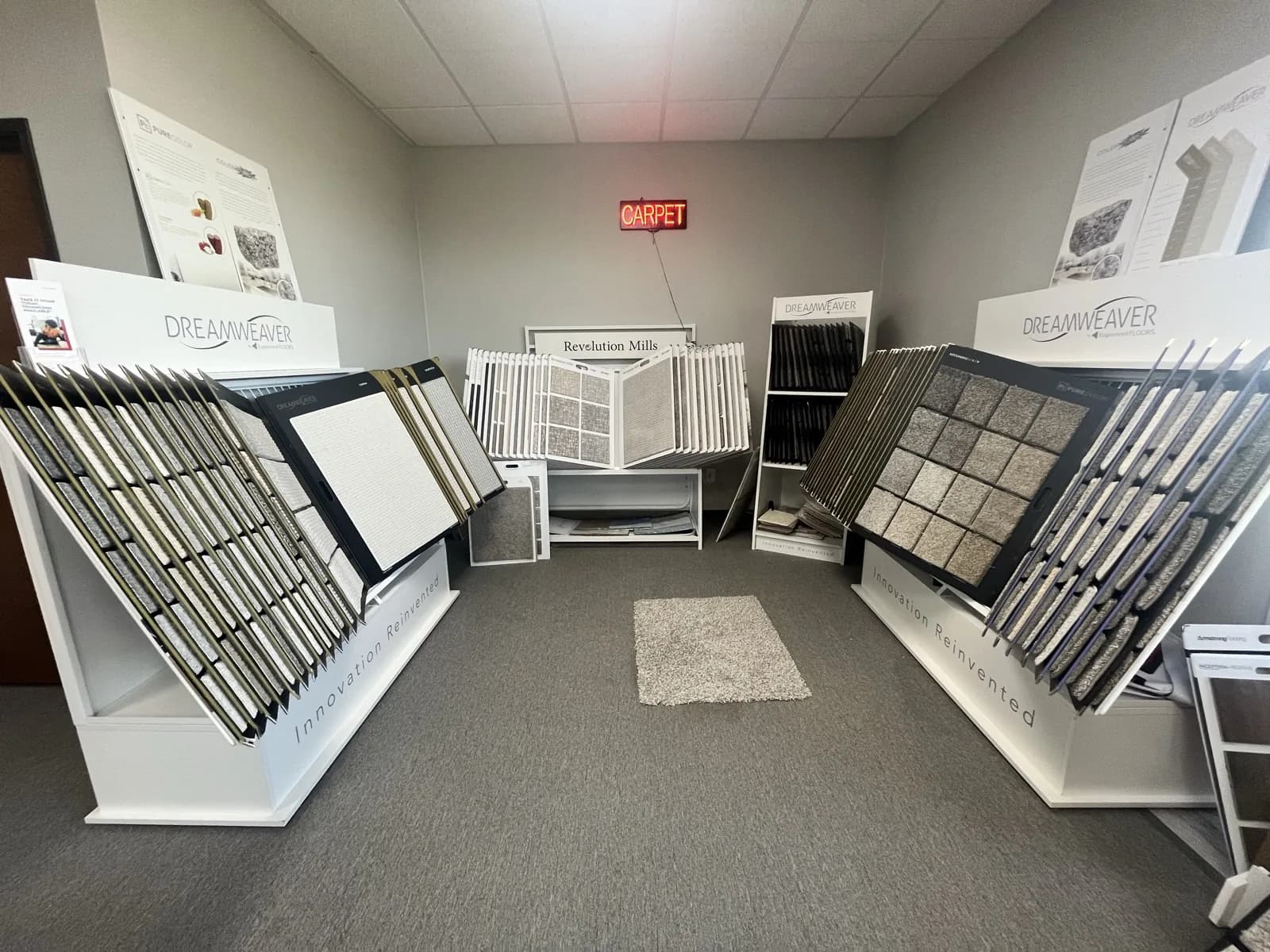 Carpet sample displays from Dreamweaver and Revolution Mills beneath the CARPET sign, At Home Flooring showroom, Wylie TX