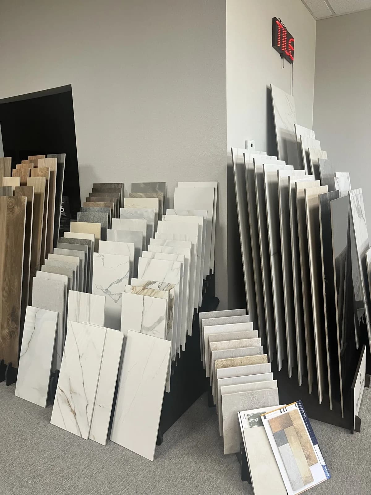 Large-format tile slabs leaning on the rack wall at the At Home Flooring showroom, Wylie TX
