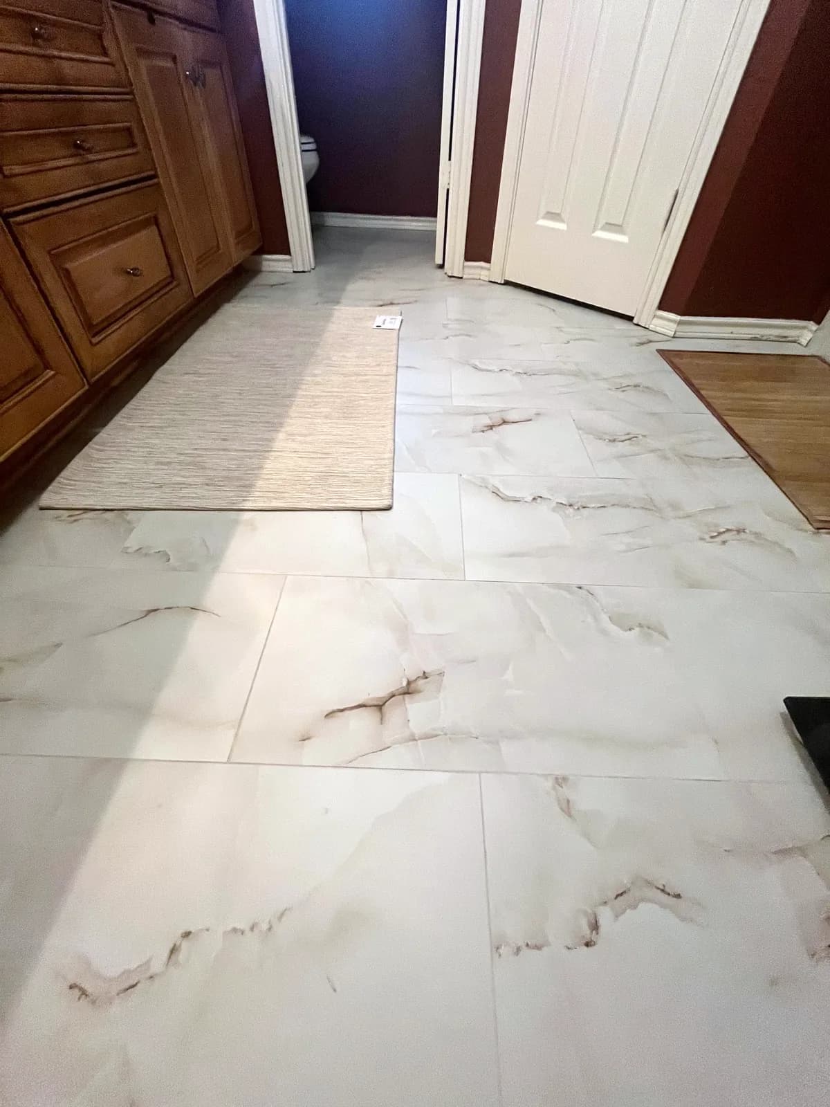 Bathroom floor in marble-look large-format tile matching the shower, Rockwall, TX